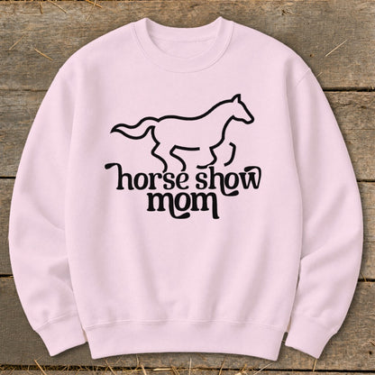 Pink crewneck sweatshirt with a black outline of a horse and "horse show mom" text.
