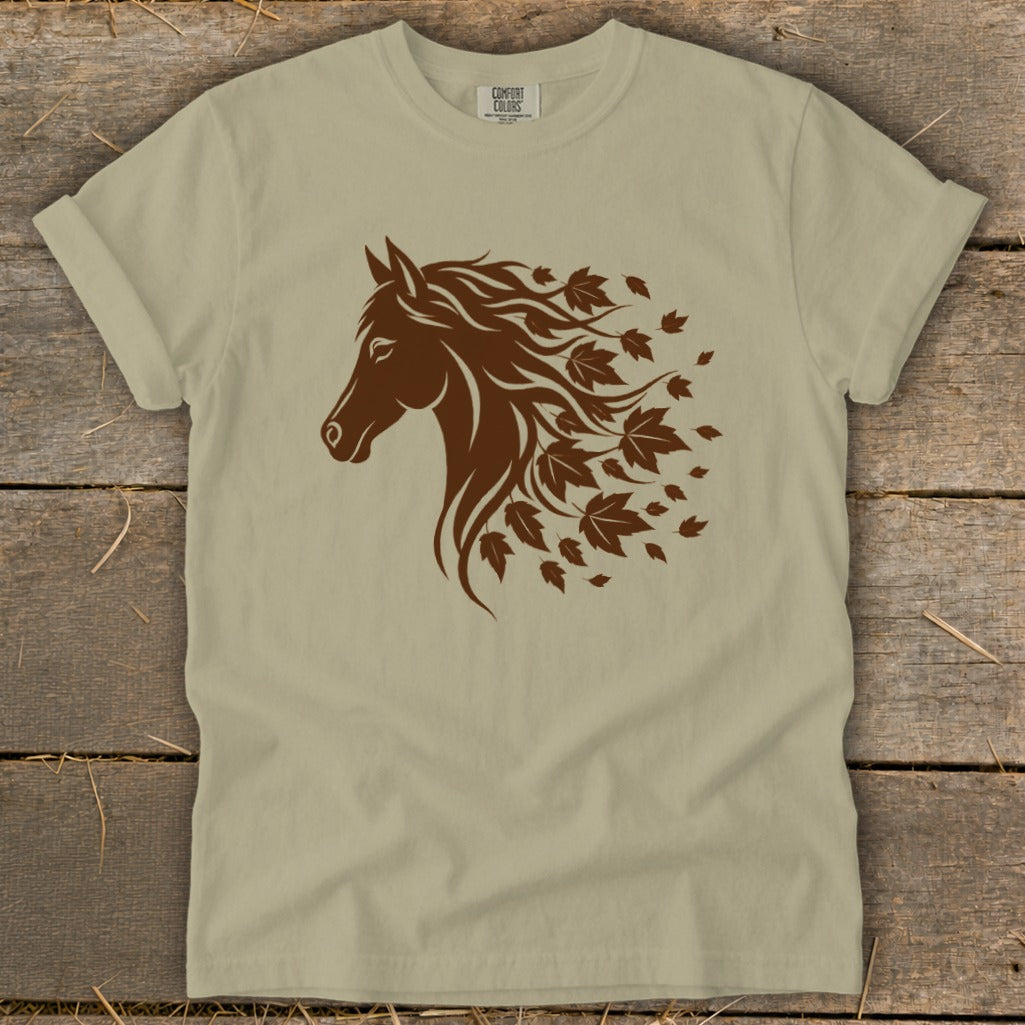 Brown horse head silhouette with flowing mane made of leaves on a tan t-shirt.