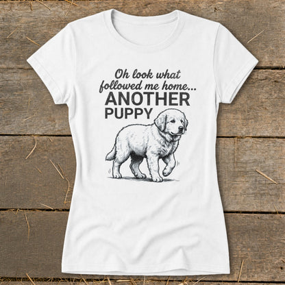 White t-shirt with a drawing of a puppy and text "Oh look what followed me home... ANOTHER PUPPY".