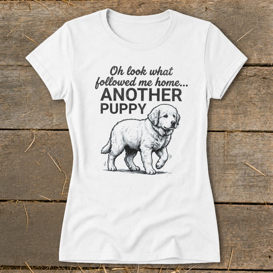 White t-shirt with a drawing of a puppy and text "Oh look what followed me home... ANOTHER PUPPY".
