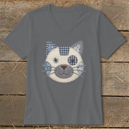 Grey v-neck t-shirt with a stitched cat face appliqué made of blue and white patterned fabric.