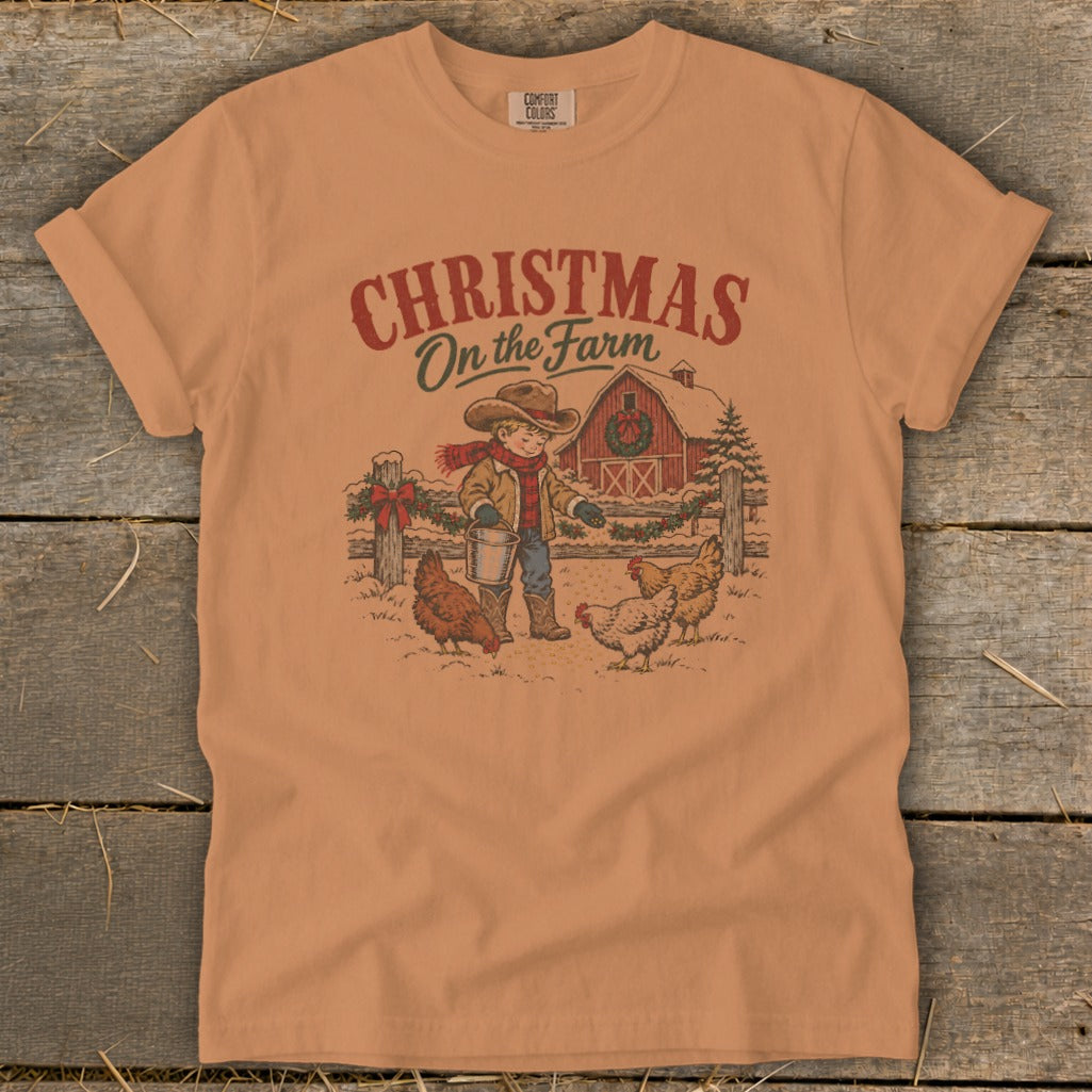 Shirt graphic: Christmas On the Farm with boy feeding chickens near barn.