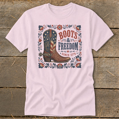 Pink t-shirt with cowboy boot graphic: "Boots & Freedom Since 1776".