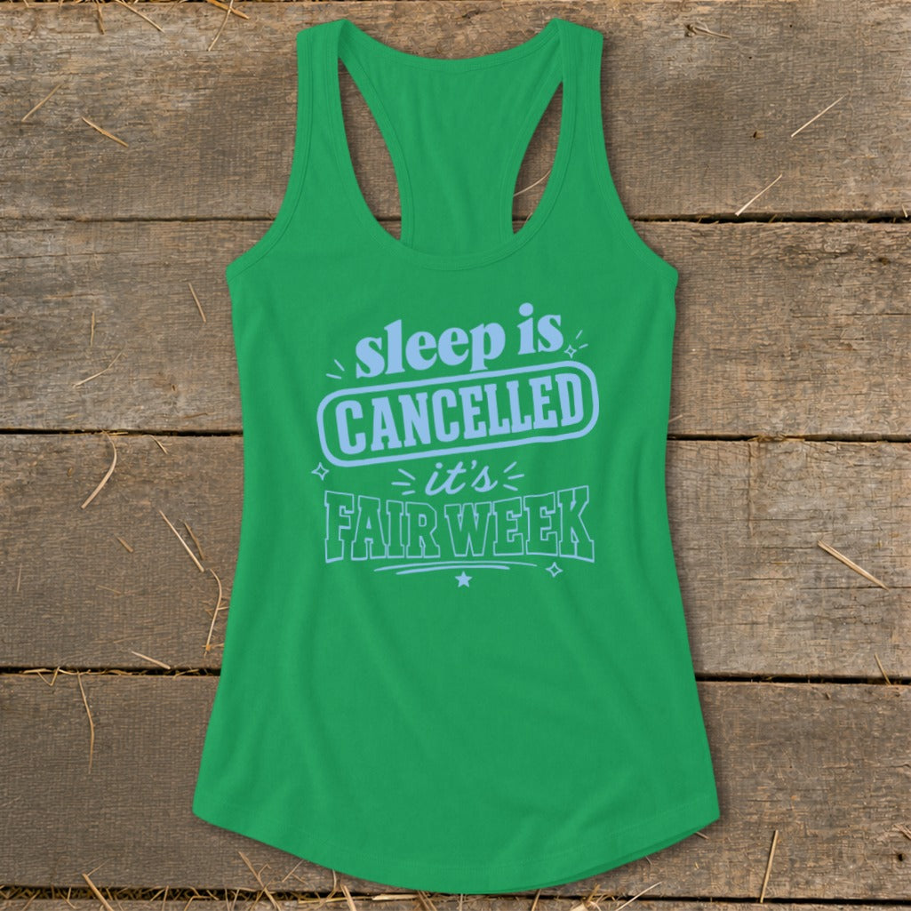 Green tank top with "sleep is CANCELLED it's FAIR WEEK" text in light blue.