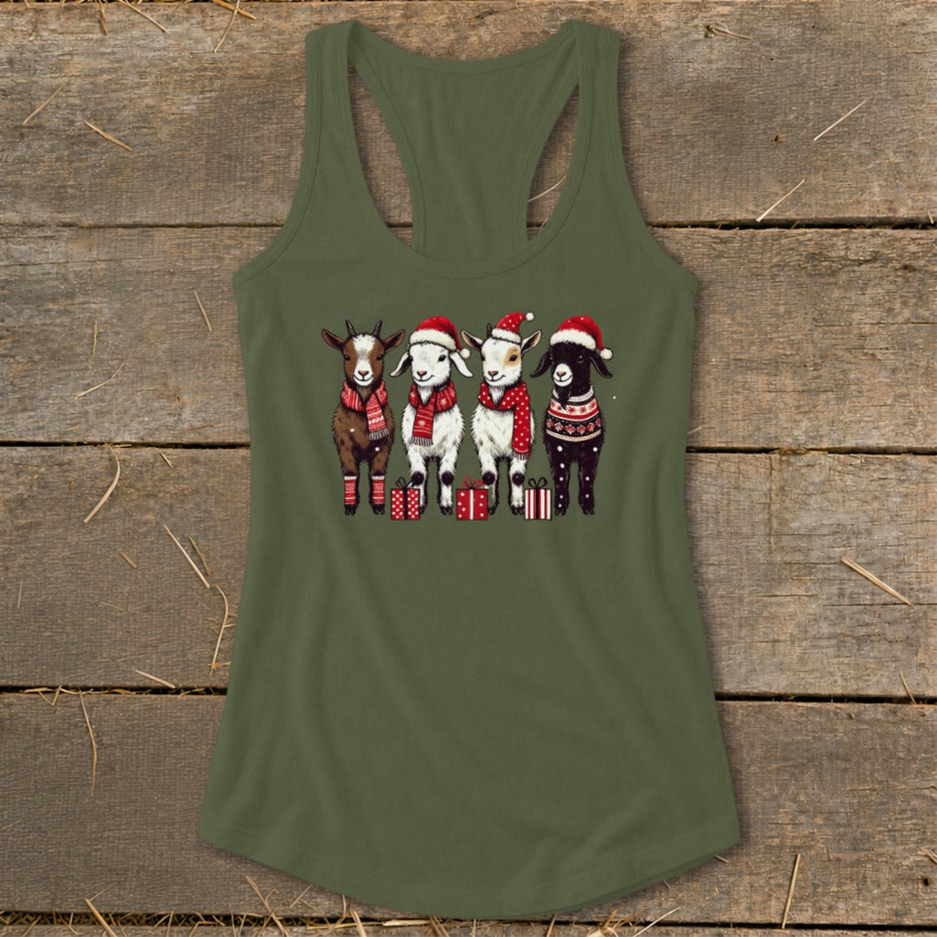 Four goats wearing Santa hats, scarves, and sweaters stand with Christmas gifts.