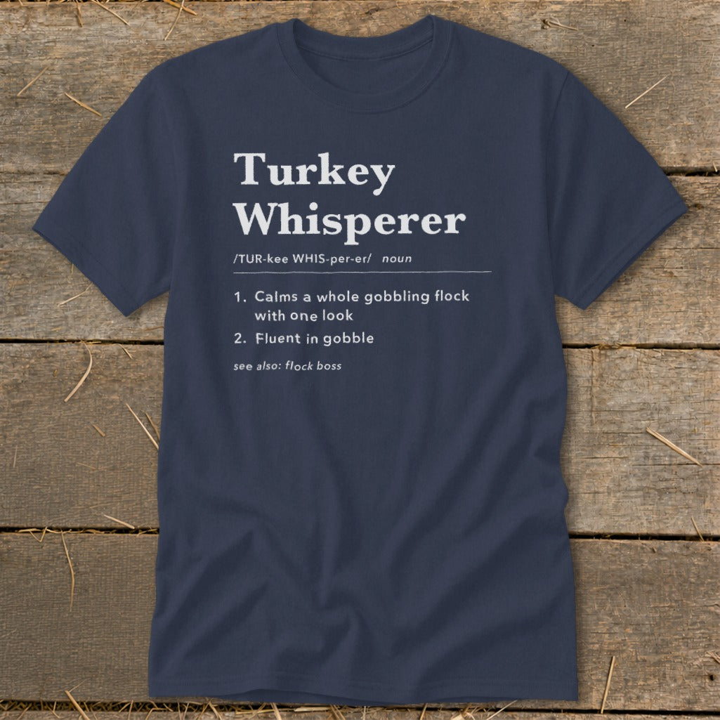 Navy t-shirt with "Turkey Whisperer" definition: calms flock, fluent in gobble.