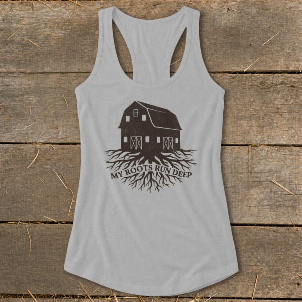 Light gray tank top with dark brown barn and roots graphic with text.