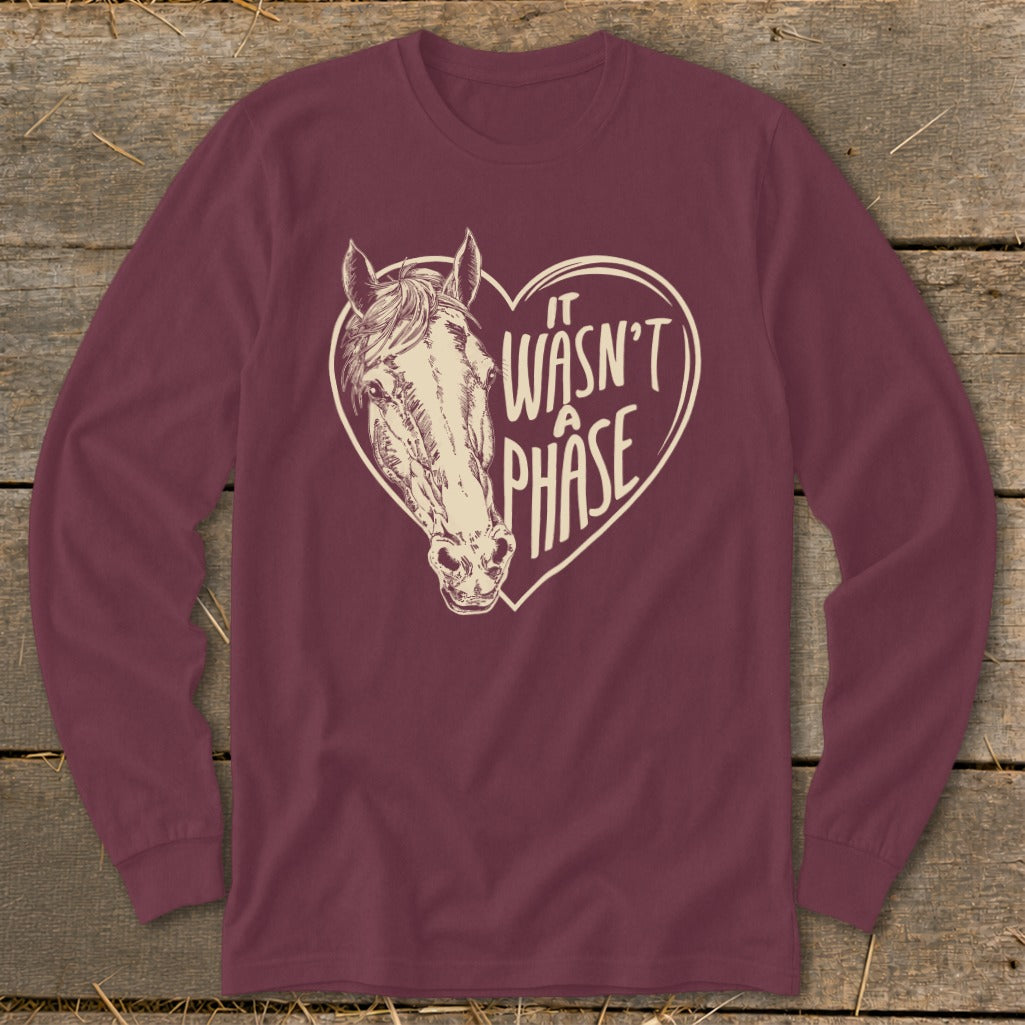 Maroon long-sleeve shirt with horse head inside a heart, text "IT WASN'T A PHASE".