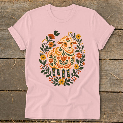 Pink t-shirt with folk art sheep design surrounded by floral wreath.