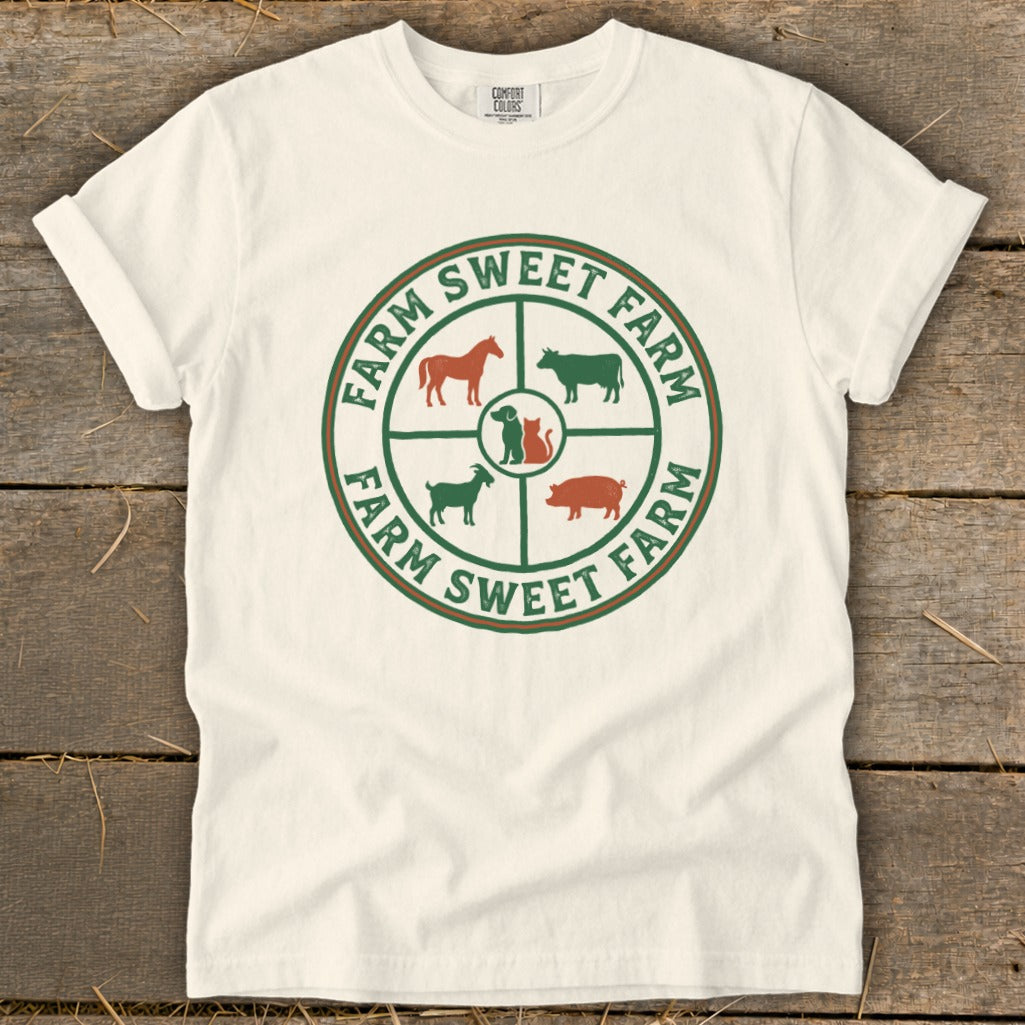 White t-shirt with circular farm animal logo and "Farm Sweet Farm" text.