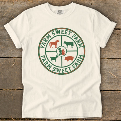 White t-shirt with circular farm animal logo and "Farm Sweet Farm" text.