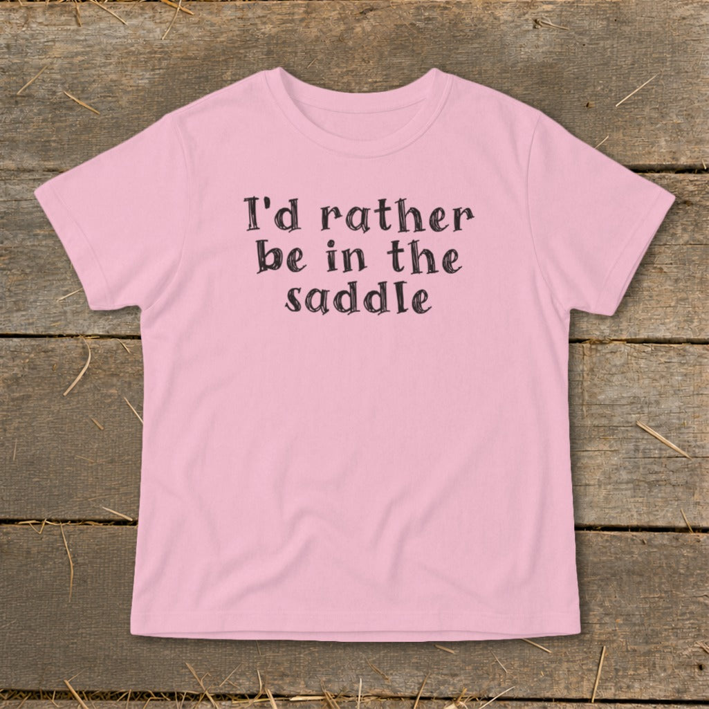 Pink t-shirt with black text reading "I'd rather be in the saddle".