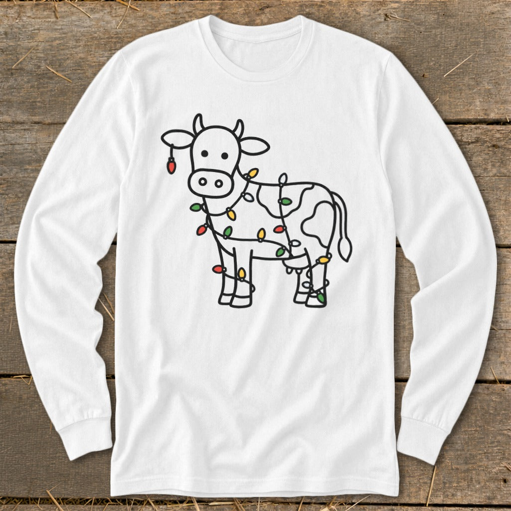 White long-sleeve shirt with a black outline drawing of a cow wrapped in colorful Christmas lights.