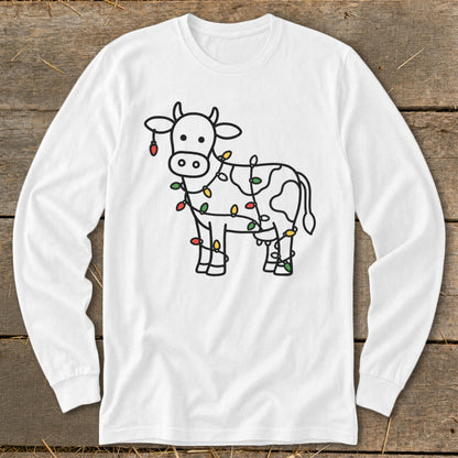 White long-sleeve shirt with a black outline drawing of a cow wrapped in colorful Christmas lights.