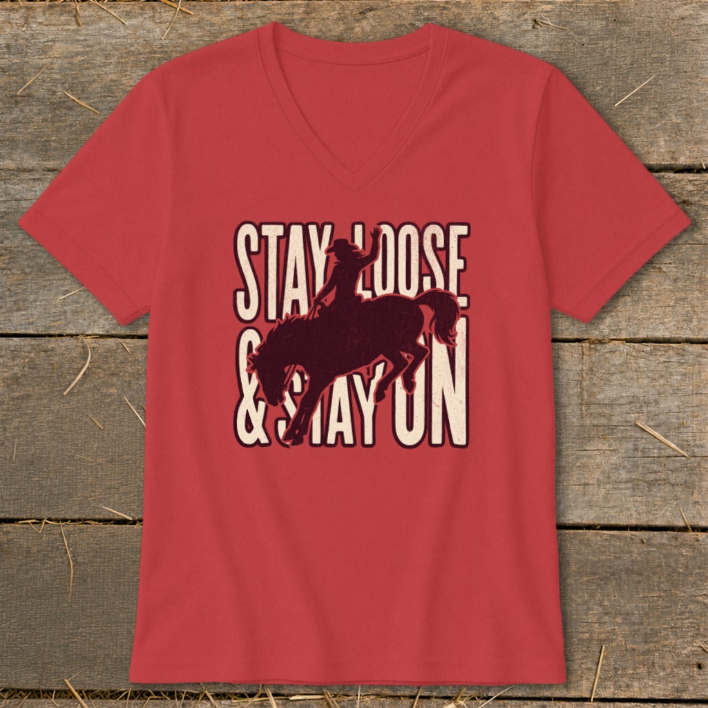 Red v-neck t-shirt with "STAY LOOSE & STAY ON" text and bucking bronco graphic.