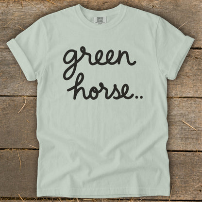 Light green t-shirt with black cursive text "green horse.."