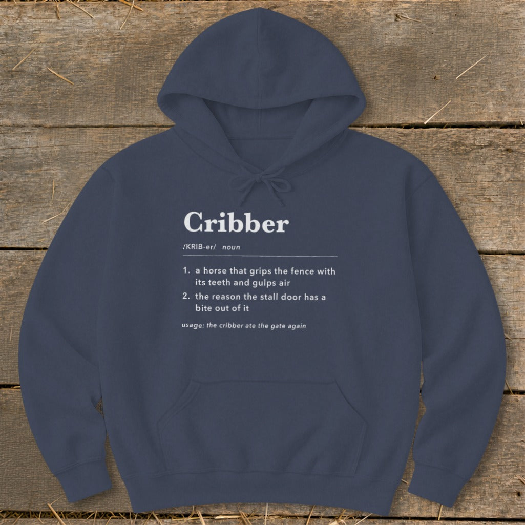 Navy blue hooded sweatshirt featuring white dictionary-style text defining the word "Cribber" for horses.