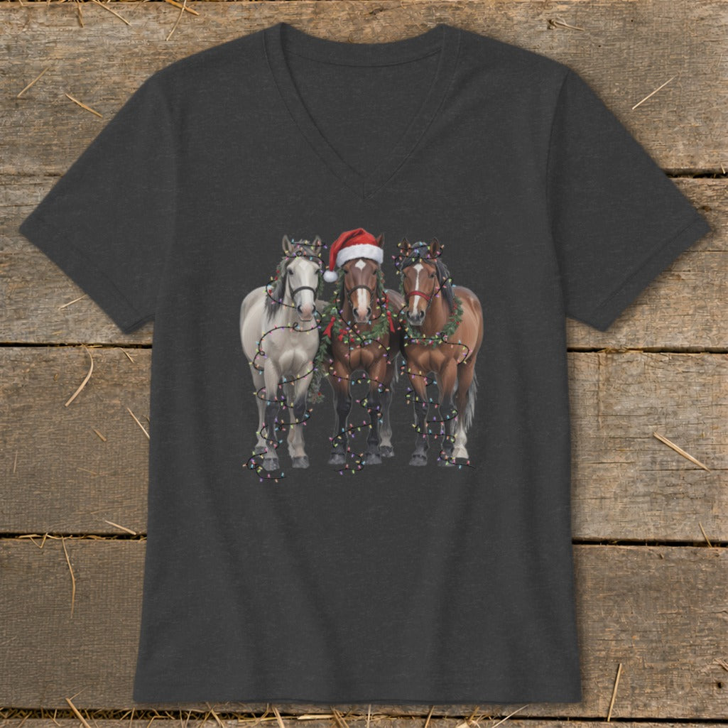 Three horses adorned with Christmas lights and a Santa hat, printed on a dark t-shirt.
