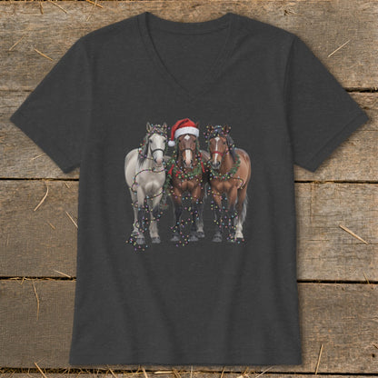 Three horses adorned with Christmas lights and a Santa hat, printed on a dark t-shirt.