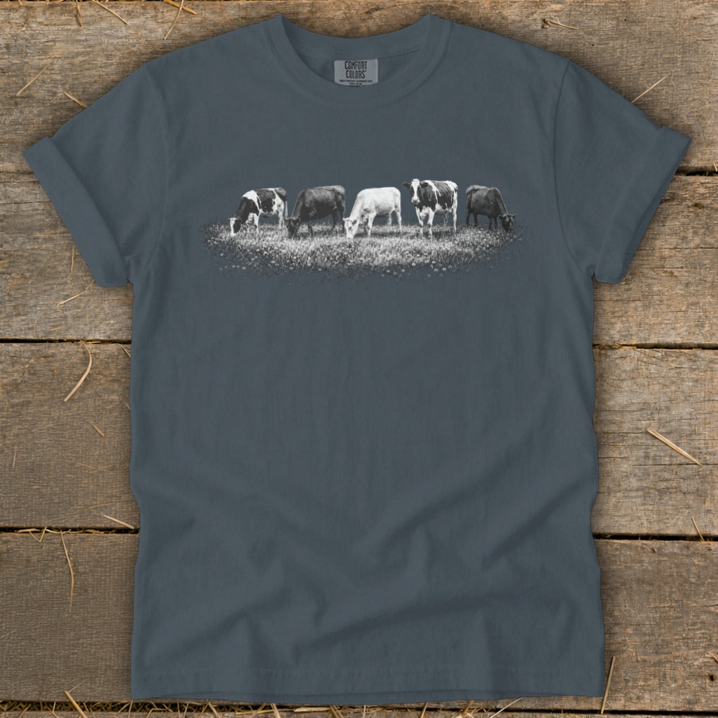T-shirt with five cows grazing in a field graphic.