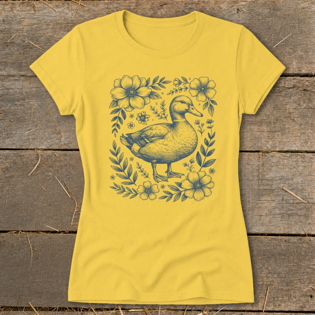 Yellow t-shirt with a blue illustration of a duck surrounded by flowers.