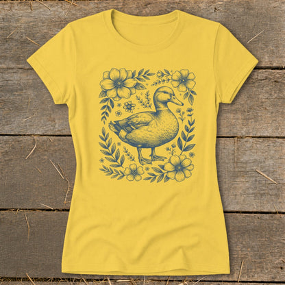 Yellow t-shirt with a blue illustration of a duck surrounded by flowers.