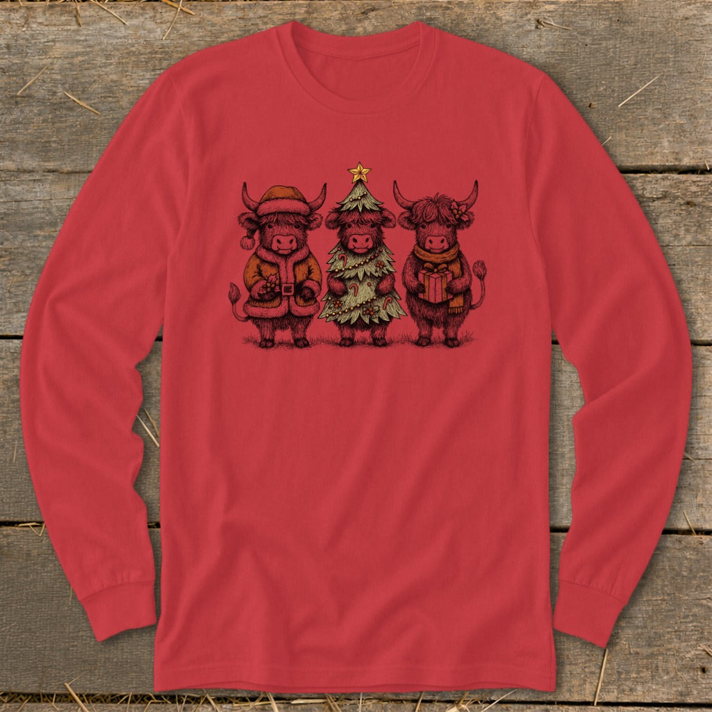 Three Highland cows in festive Christmas attire, one as Santa, one as a tree, one with a gift.