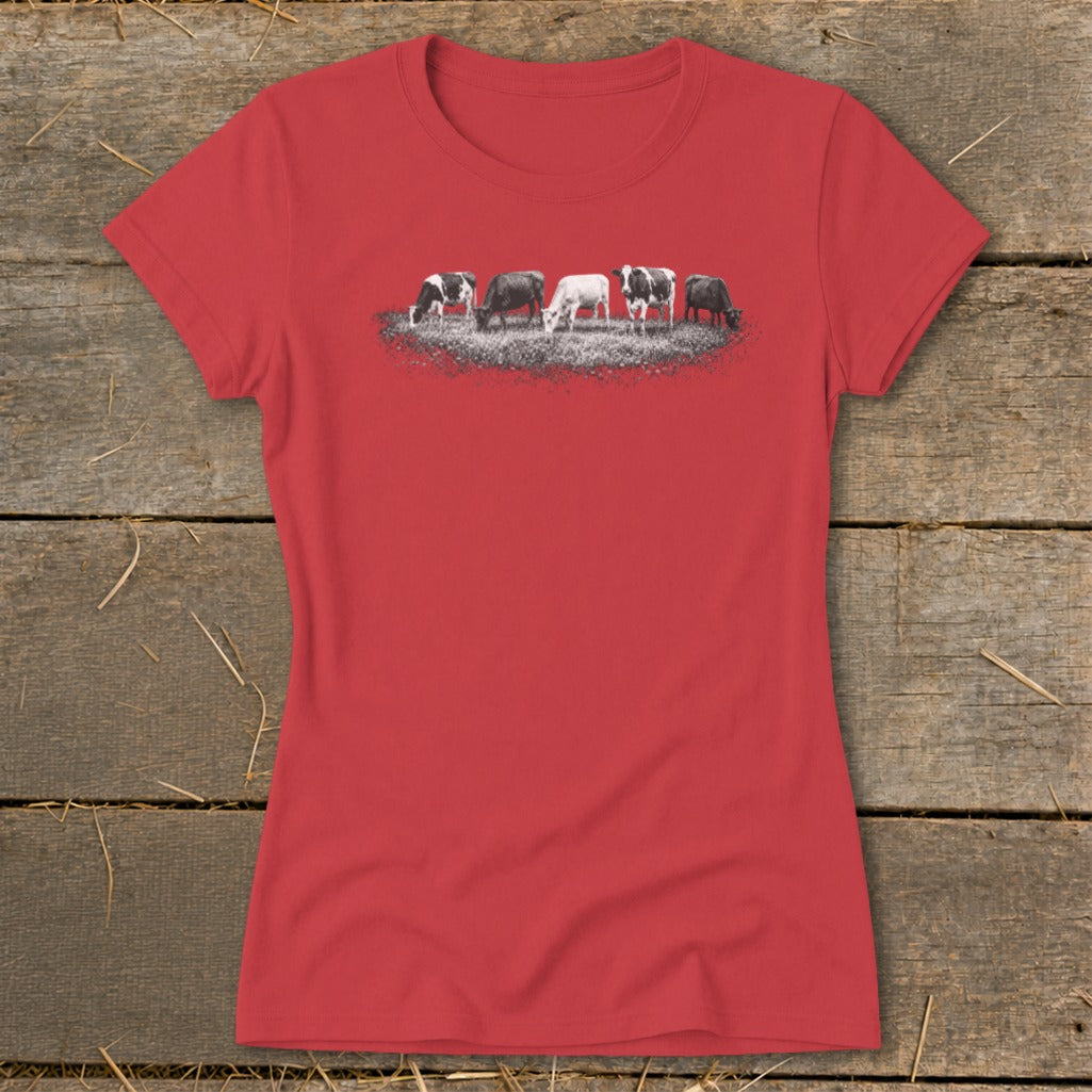 Red t-shirt with a graphic of five black and white cows grazing in grass.