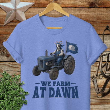Blue t-shirt with a goat driving a tractor, "WE FARM AT DAWN" text.