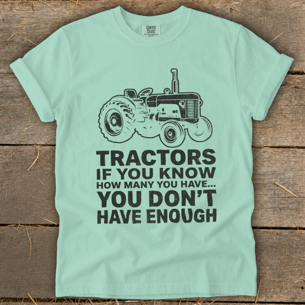 T-shirt with a black tractor graphic and the text "Tractors if you know how many you have... you don't have enough."