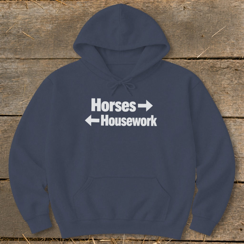 Dark blue hooded sweatshirt with white text reading "Horses" pointing right and "Housework" pointing left.