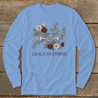 Light blue long-sleeve shirt with horse bit and floral graphic, text "GRACE IN STRIDE".