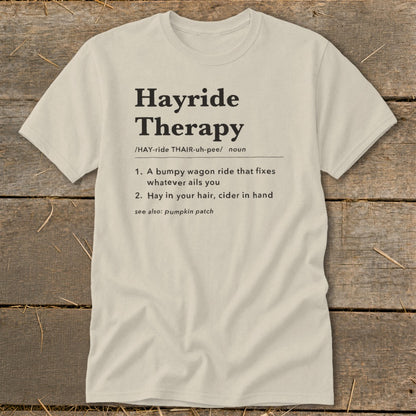 Light tan t-shirt with black text defining "Hayride Therapy".