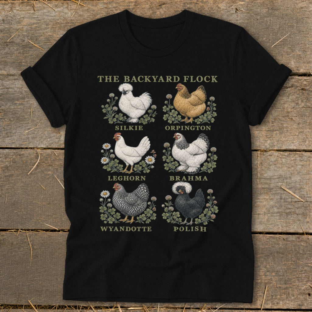 Black t-shirt with "The Backyard Flock" text and illustrations of Silkie, Orpington, Leghorn, Brahma, Wyandotte, and Polish chickens.