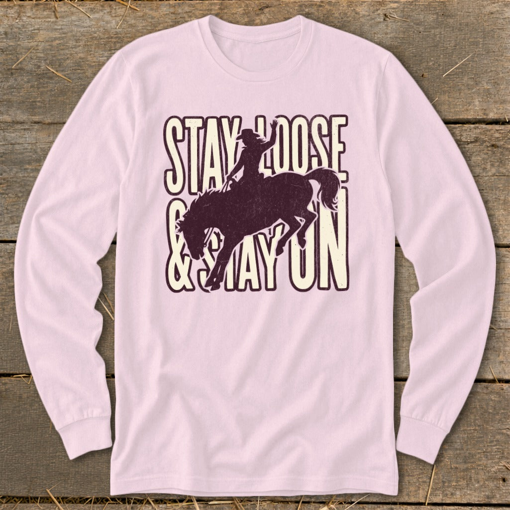 Pink long sleeve shirt with dark graphic: "STAY LOOSE & STAY ON".