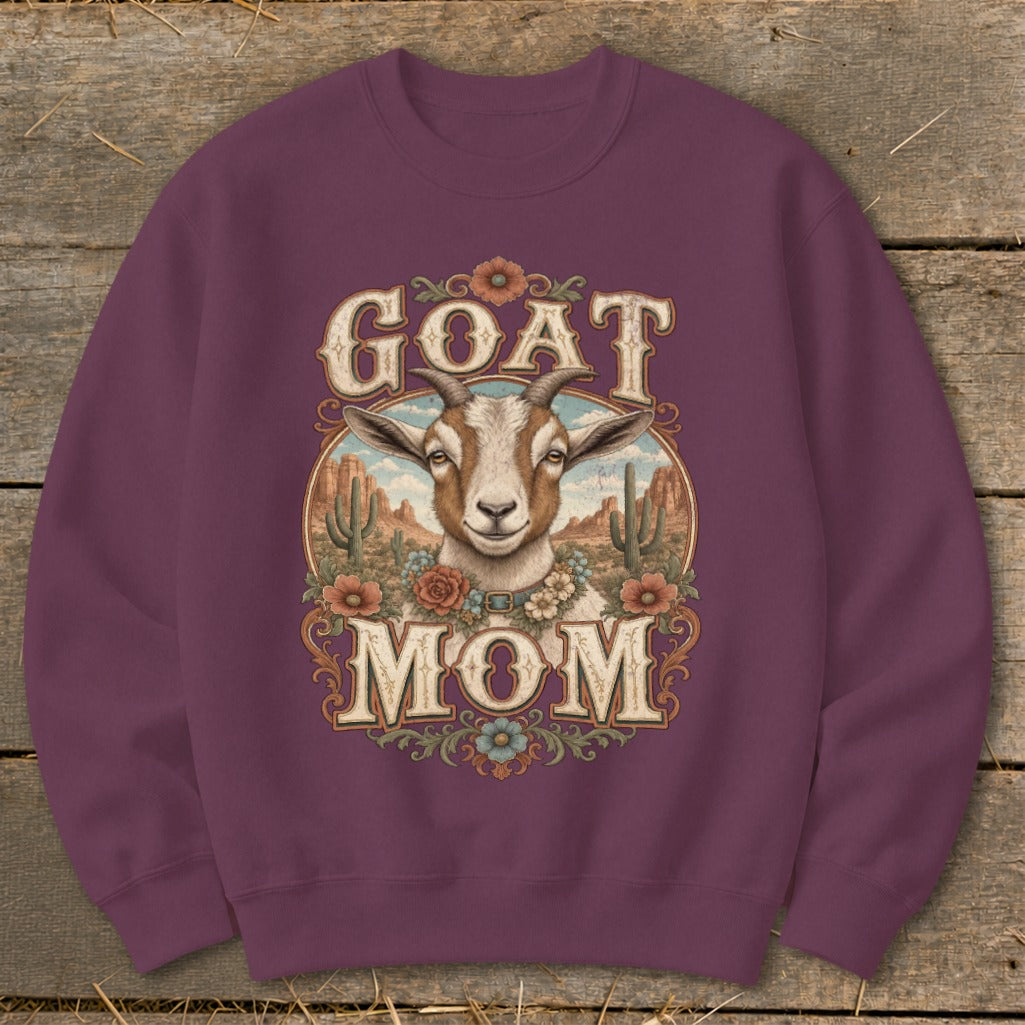 Crewneck sweatshirt with "GOAT MOM" text and a goat illustration in a desert landscape.