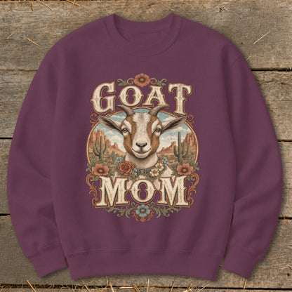 Crewneck sweatshirt with "GOAT MOM" text and a goat illustration in a desert landscape.