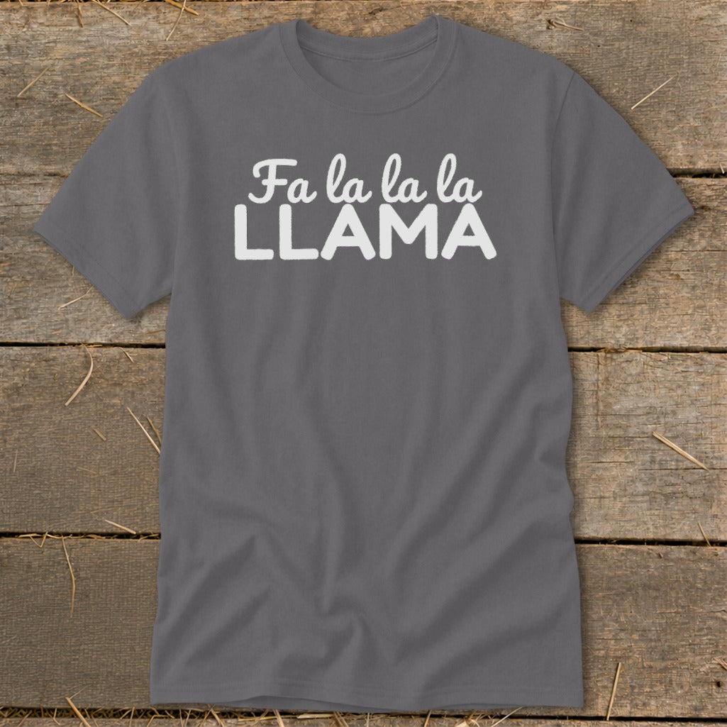 Gray t-shirt with white text "Fa la la la LLAMA" on a wooden background.