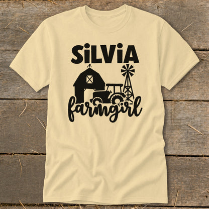 Yellow t-shirt with "Silvia farmgirl" text and farm scene silhouette.