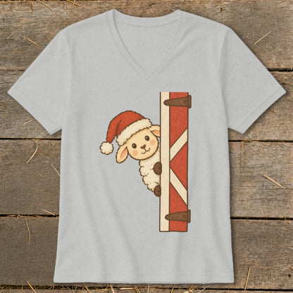 Cartoon sheep wearing Santa hat peeks from behind a red barn door.