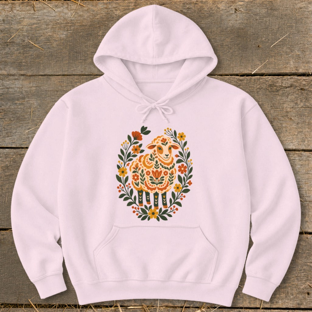 Pink hoodie with a white sheep illustration surrounded by flowers.