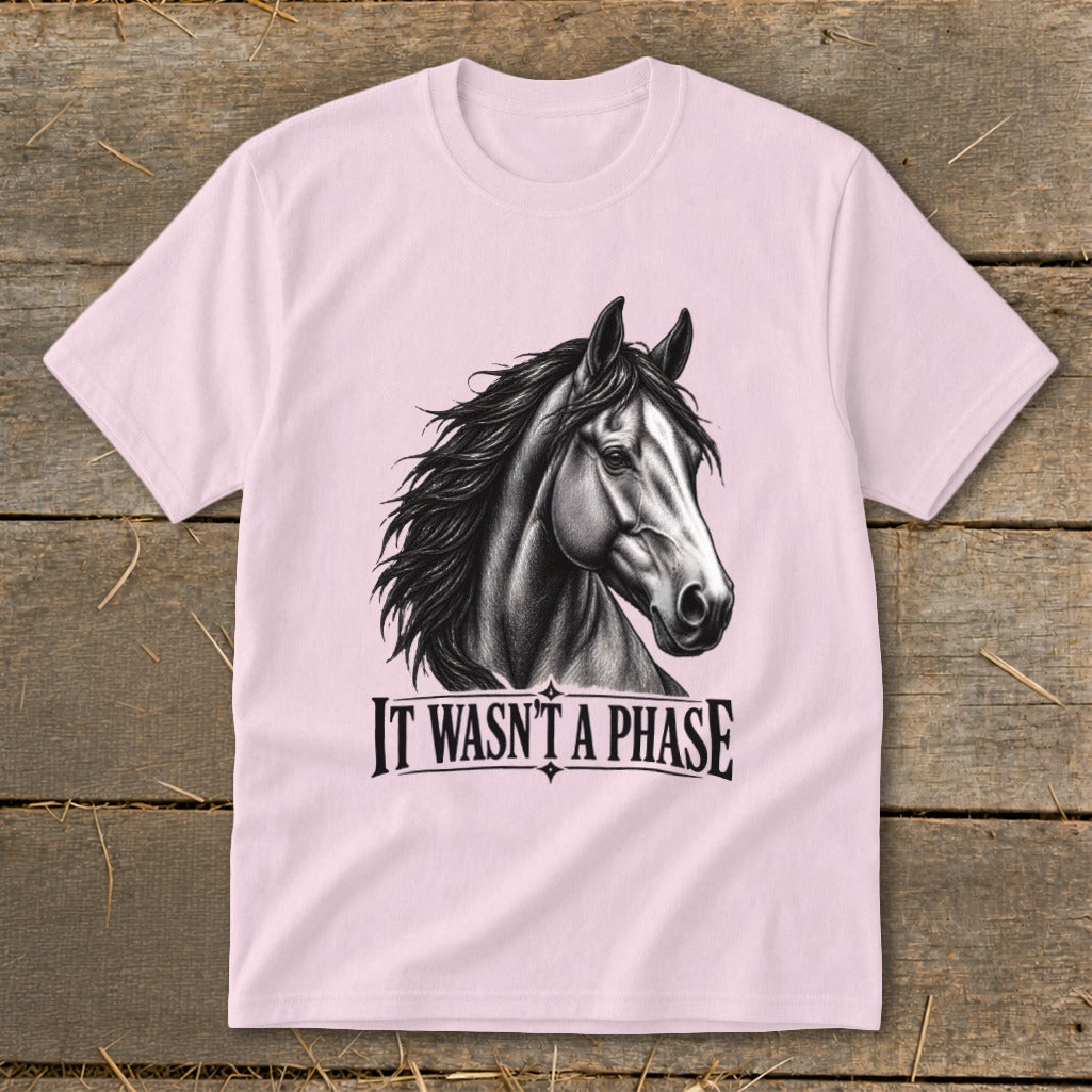 Pink t-shirt with a black and white horse head graphic and text that reads "IT WASN'T A PHASE".