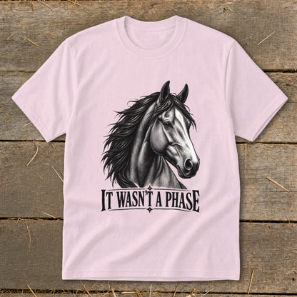Pink t-shirt with a black and white horse head graphic and text that reads "IT WASN'T A PHASE".