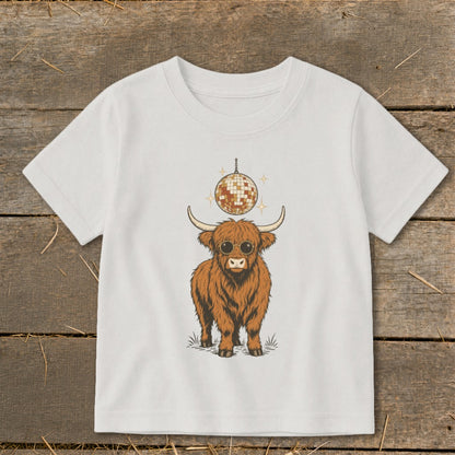 Brown Highland cow with sunglasses and a disco ball graphic on a white t-shirt.