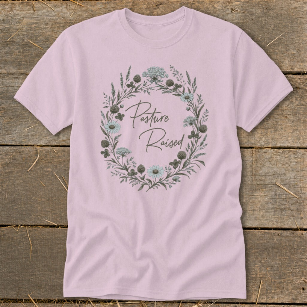 Pink t-shirt with a floral wreath graphic and "Pasture Raised" text.