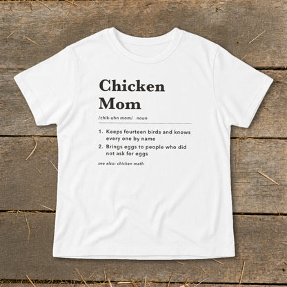 White t-shirt with black text defining "Chicken Mom" and its characteristics.