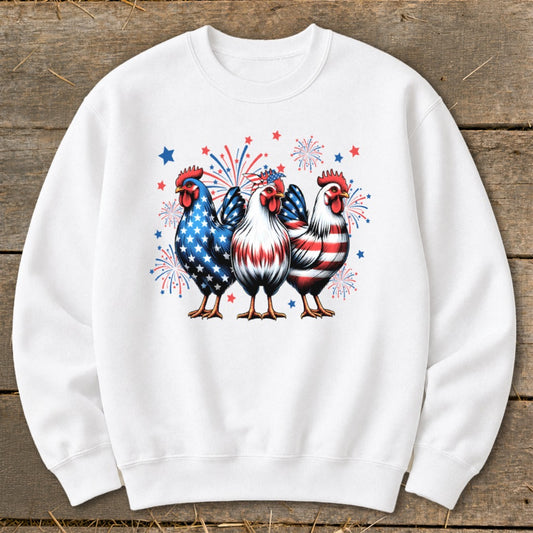 Three roosters with patriotic American flag patterns and fireworks on a white sweatshirt.