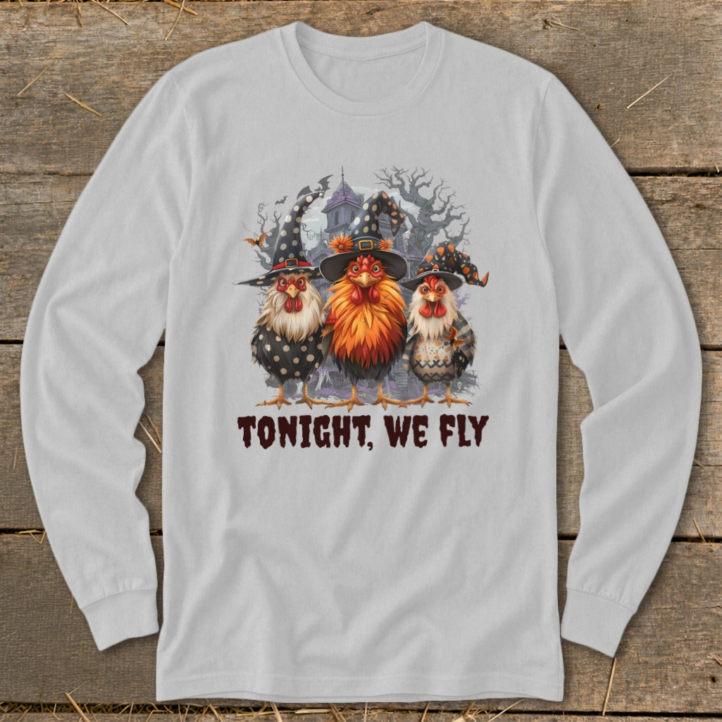 Three chickens in witch hats stand before a haunted house, with text "TONIGHT, WE FLY".