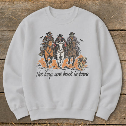 Three skeleton cowboys ride horses with text "The boys are back in town."