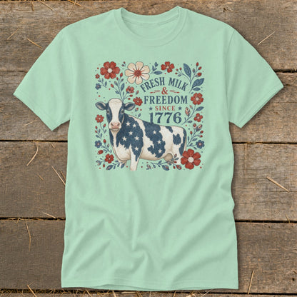 Cow with American flag pattern on t-shirt with text "Fresh Milk & Freedom Since 1776".
